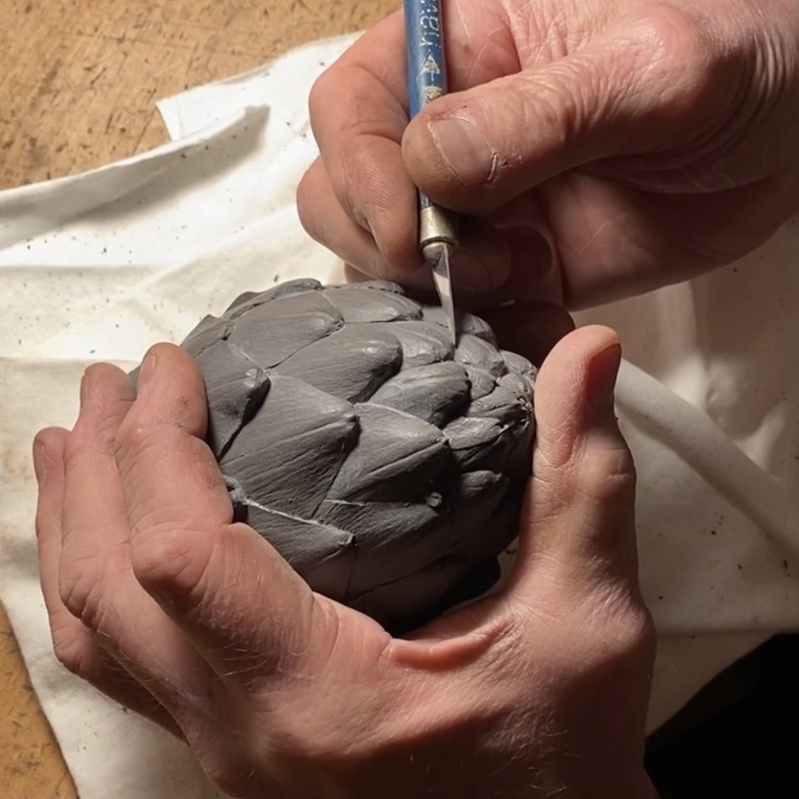 hands working on artichoke master