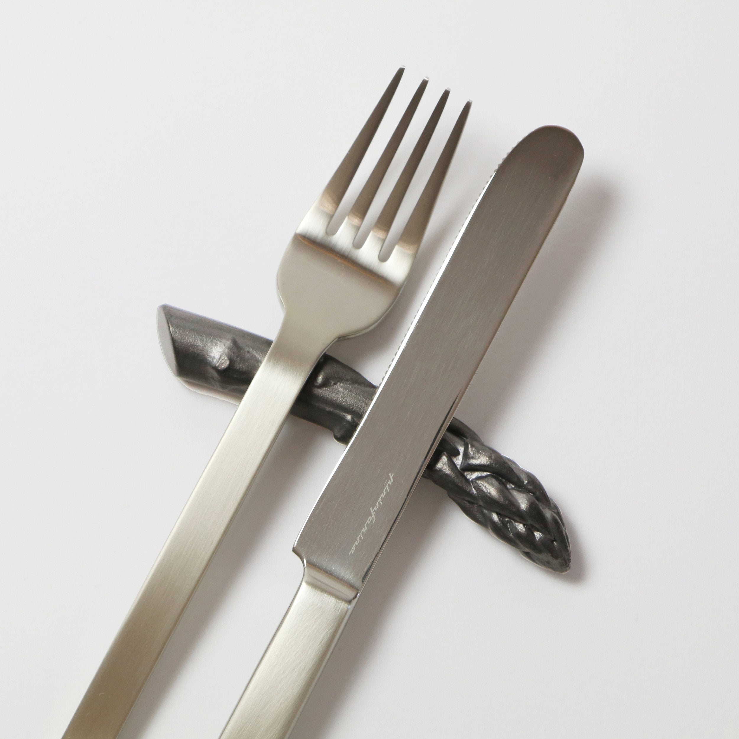 dark grey vegetable shaped cutlery rest with fork and knife
