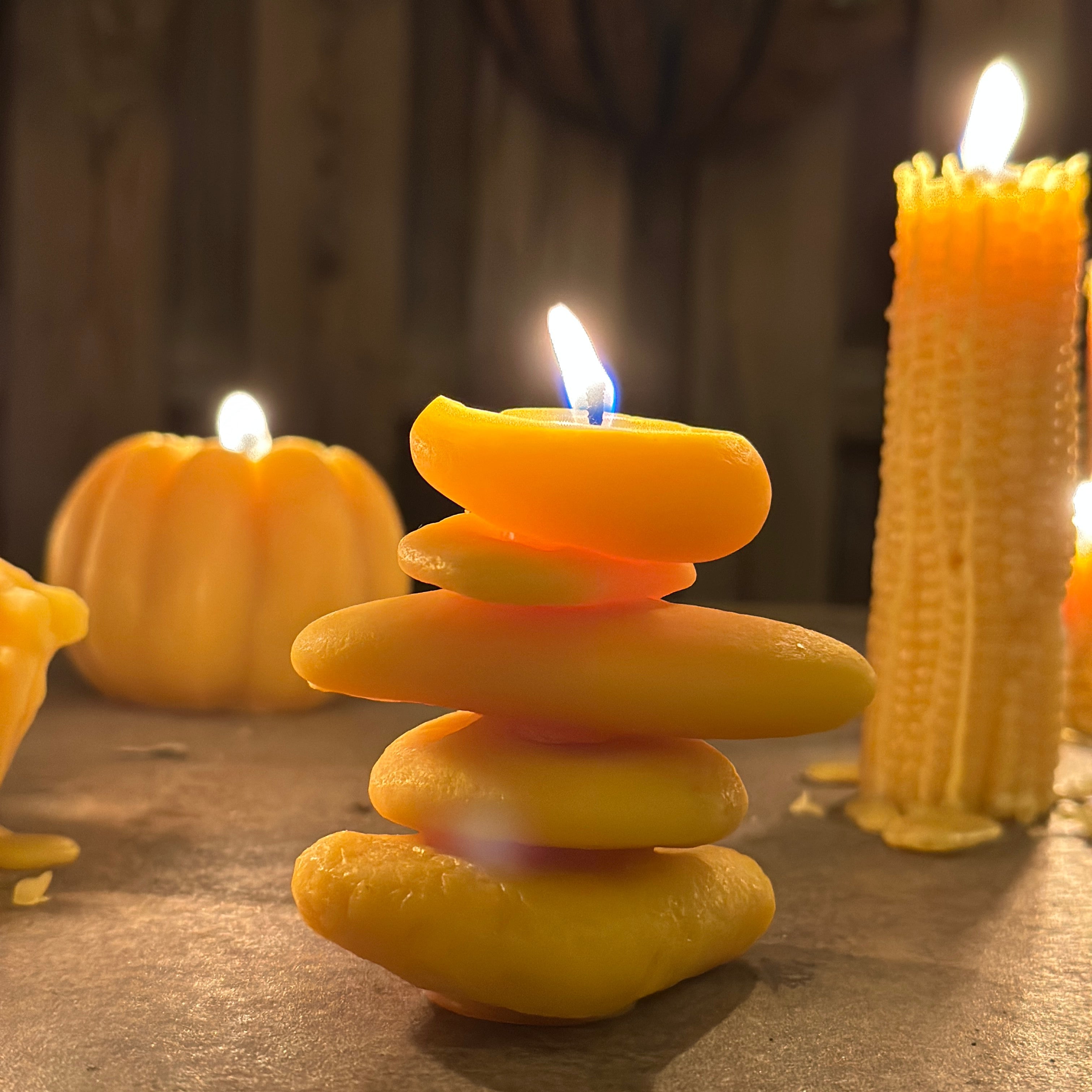 cairn beeswax candle aflame