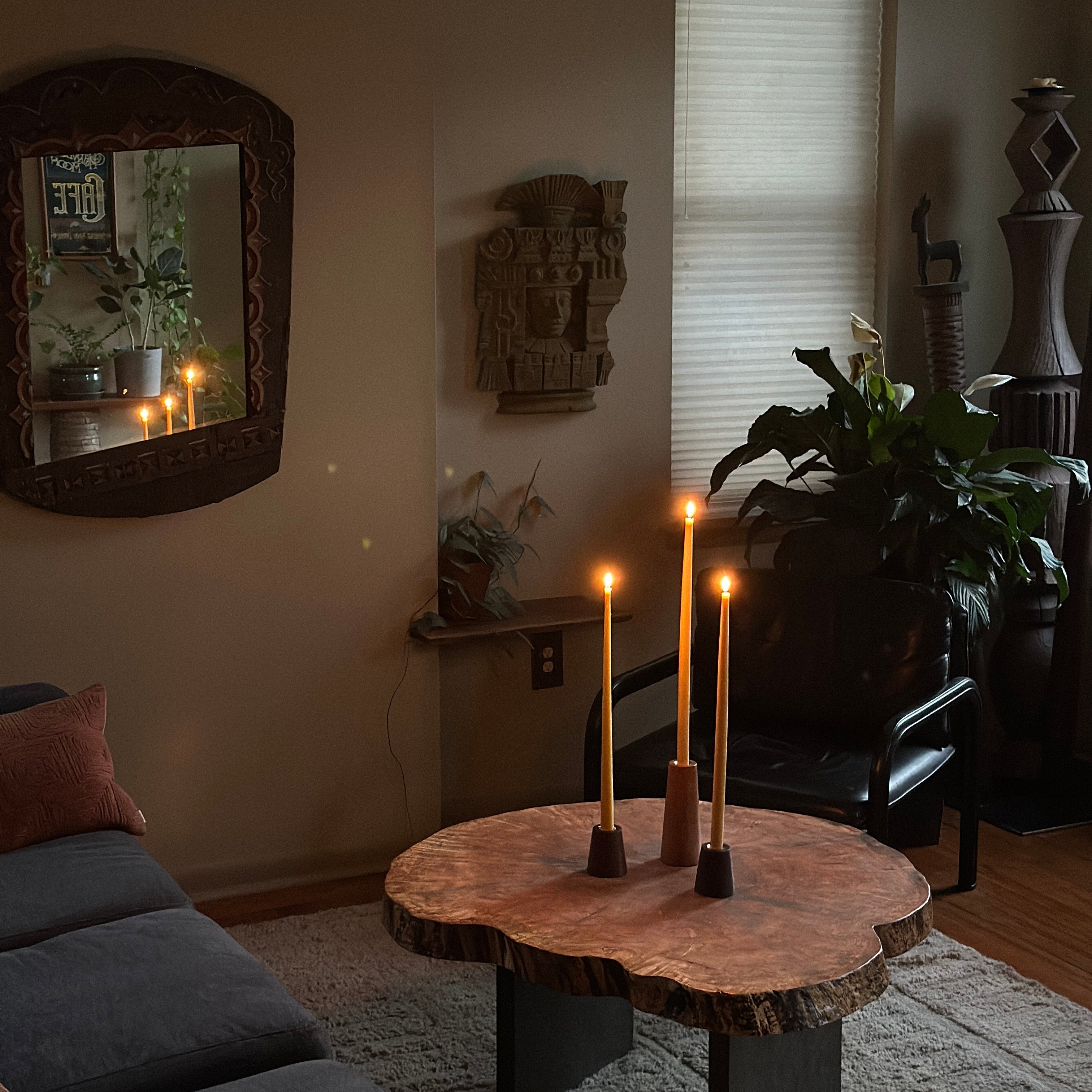 Living room with a round wooden table, chairs, and decorative items.
