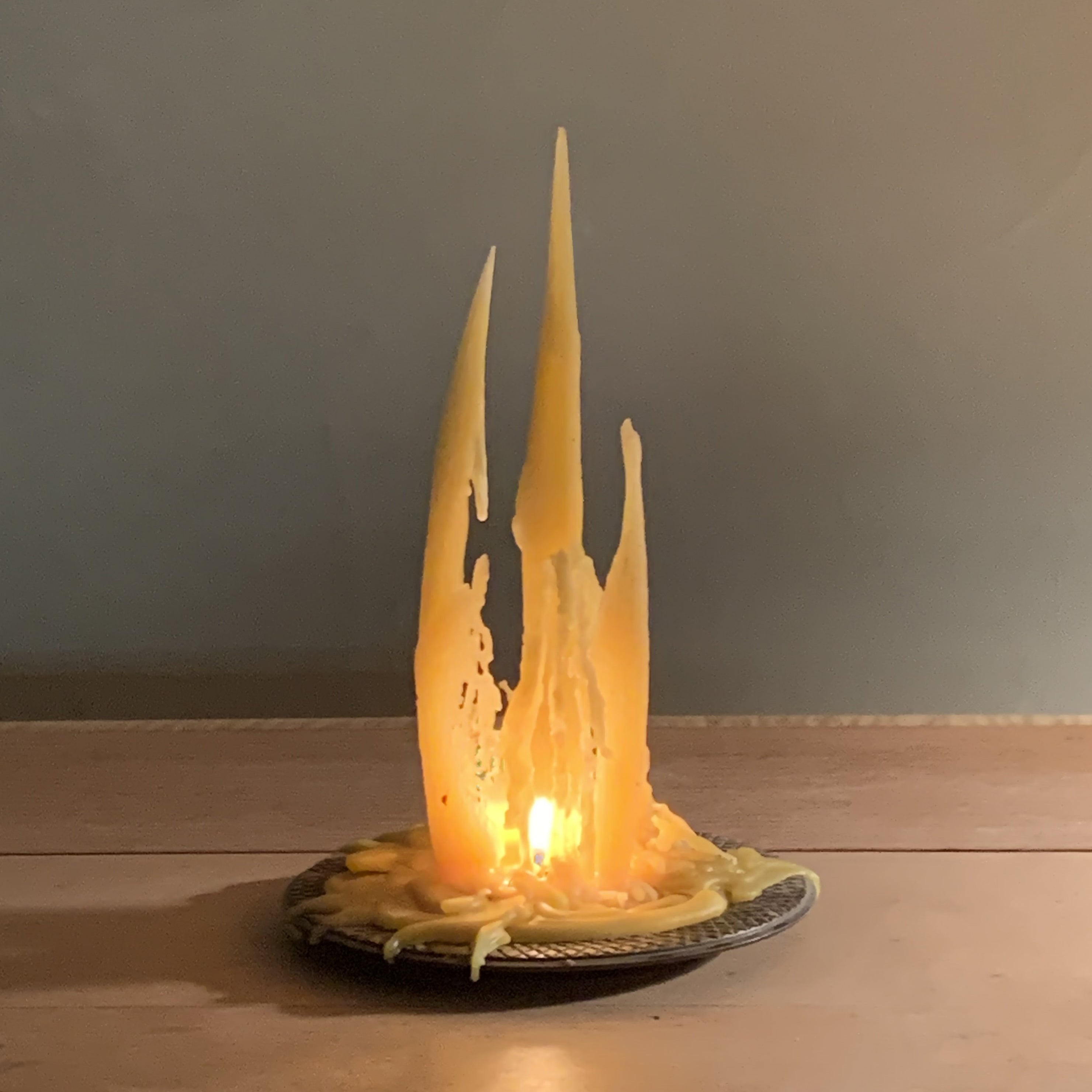 candle lit with three spires