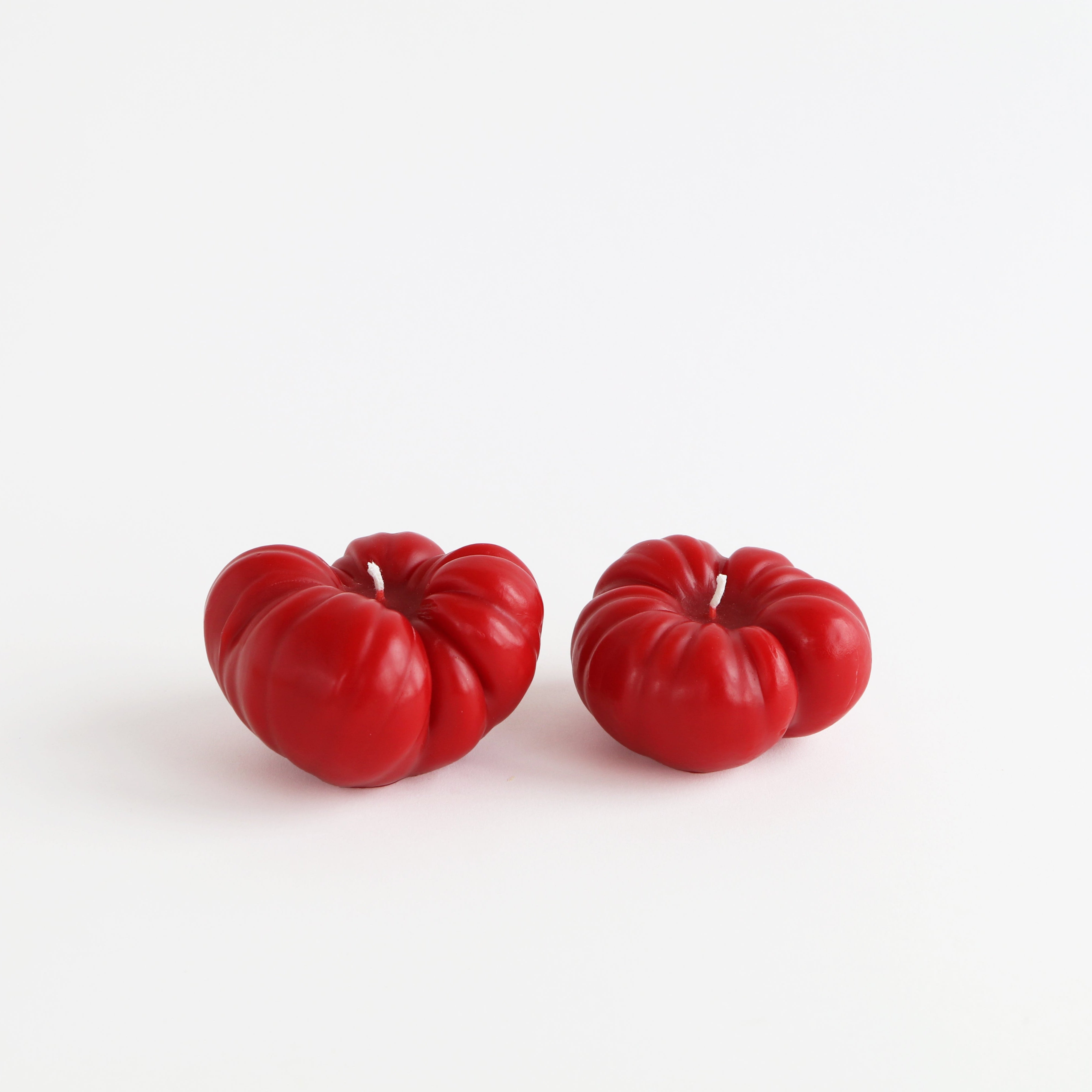 large and small red tomato candles