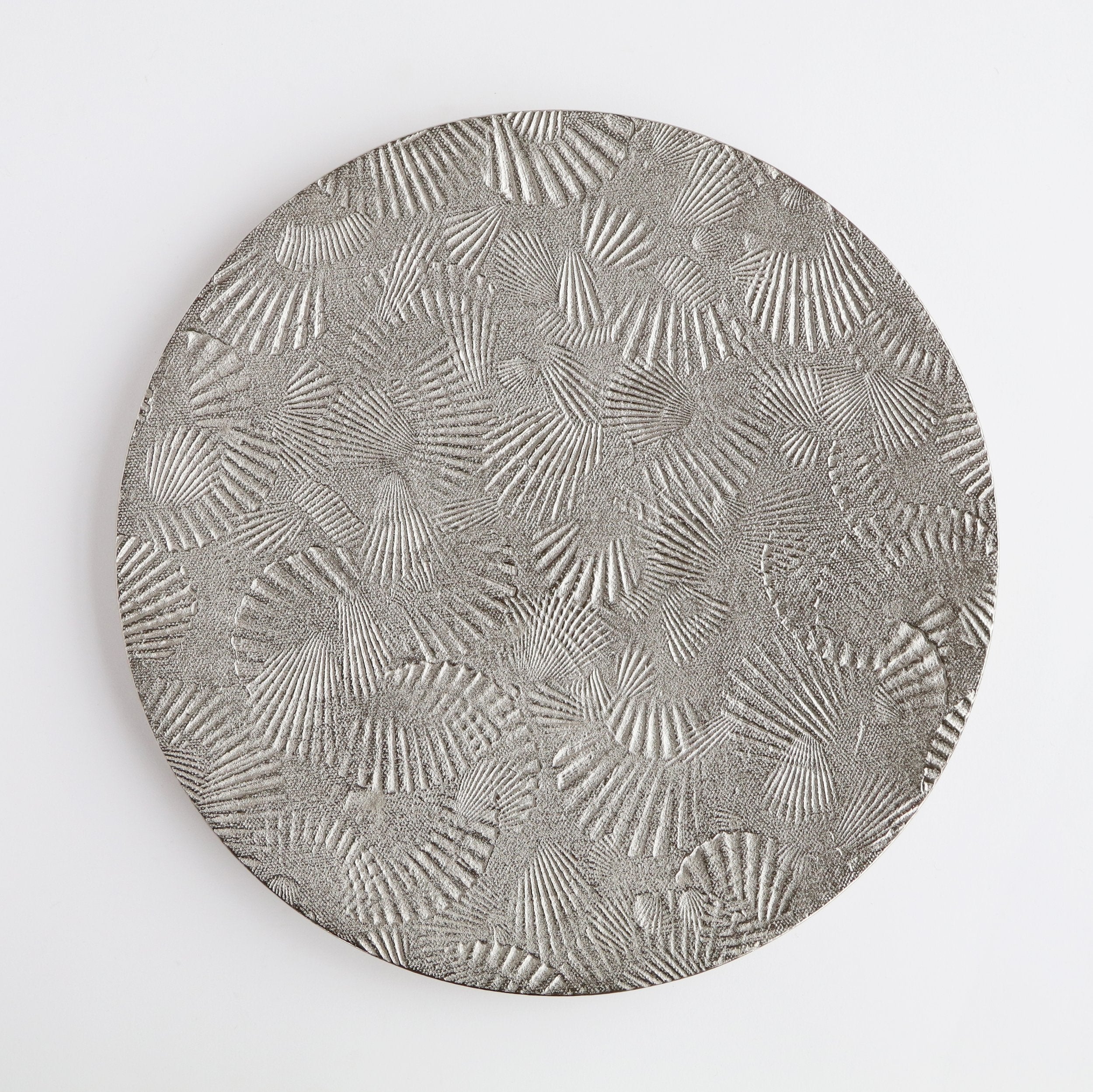 round silver platter with scallop shell impressions