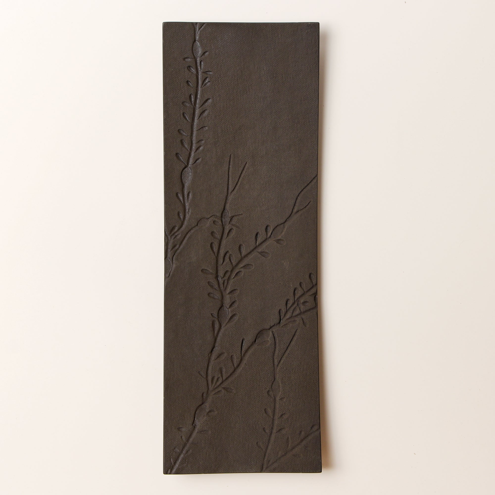 black metal platter with seaweed impressions