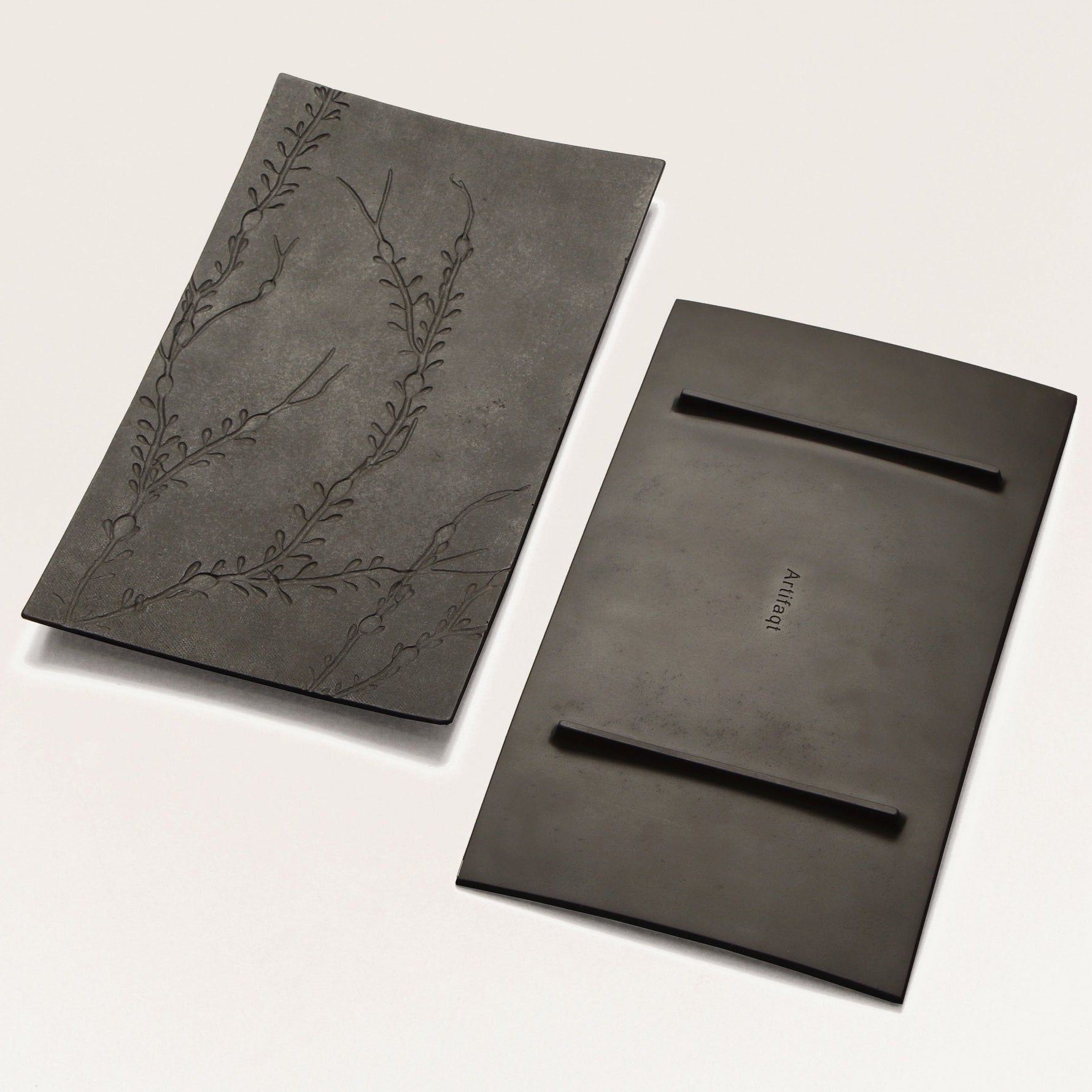 front and back of black metal platter with seaweed texture