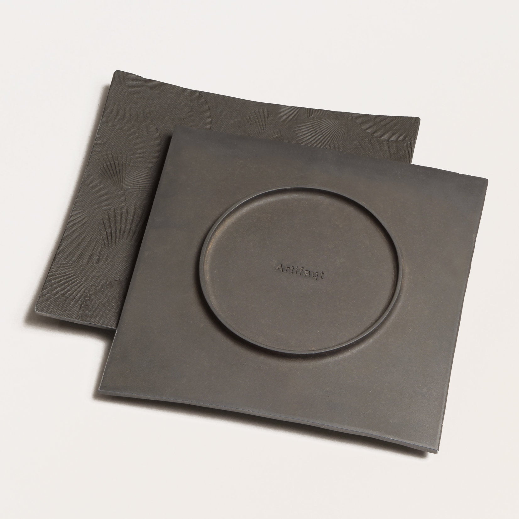front and back of black metal platter with scallop texture