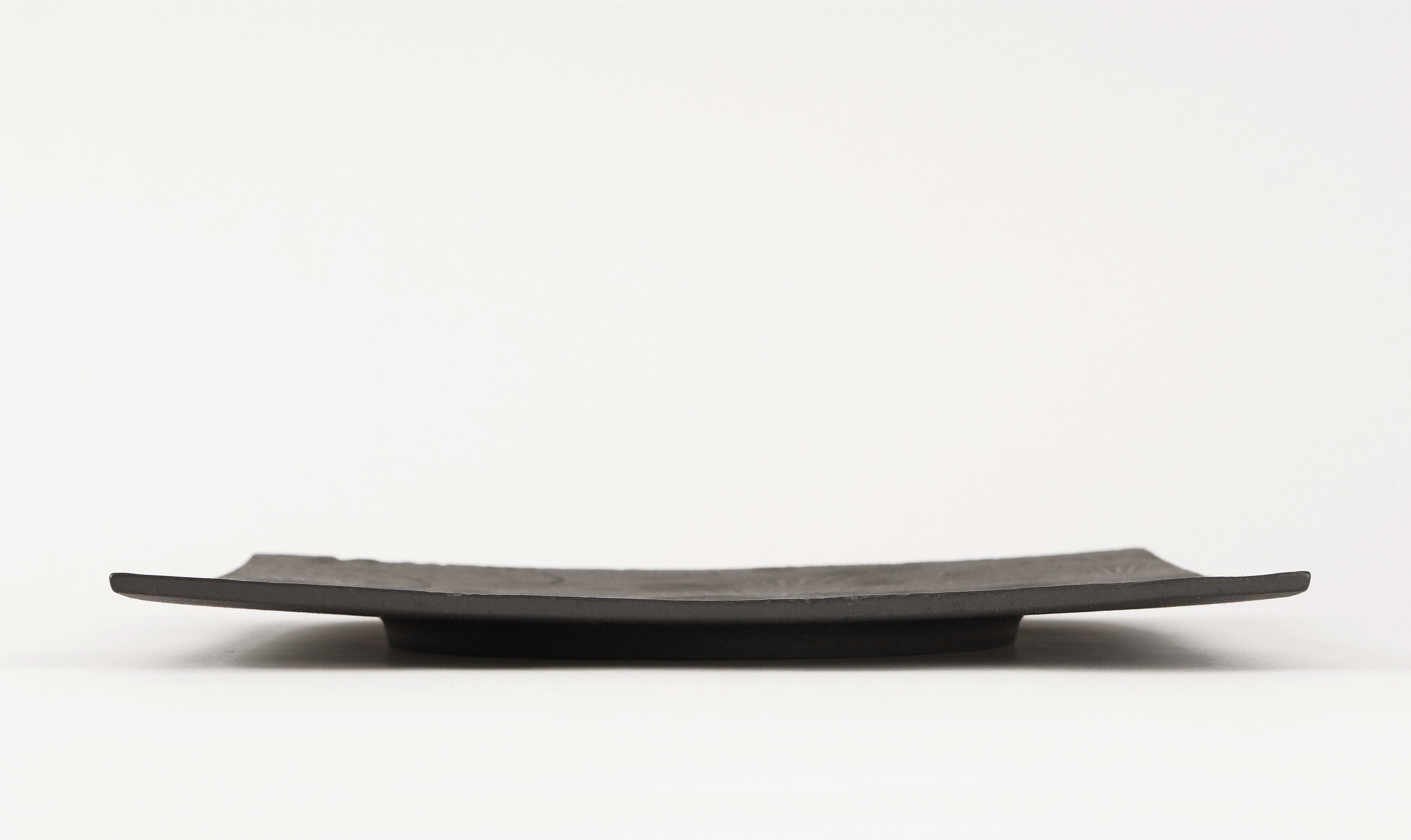side view of black metal tray