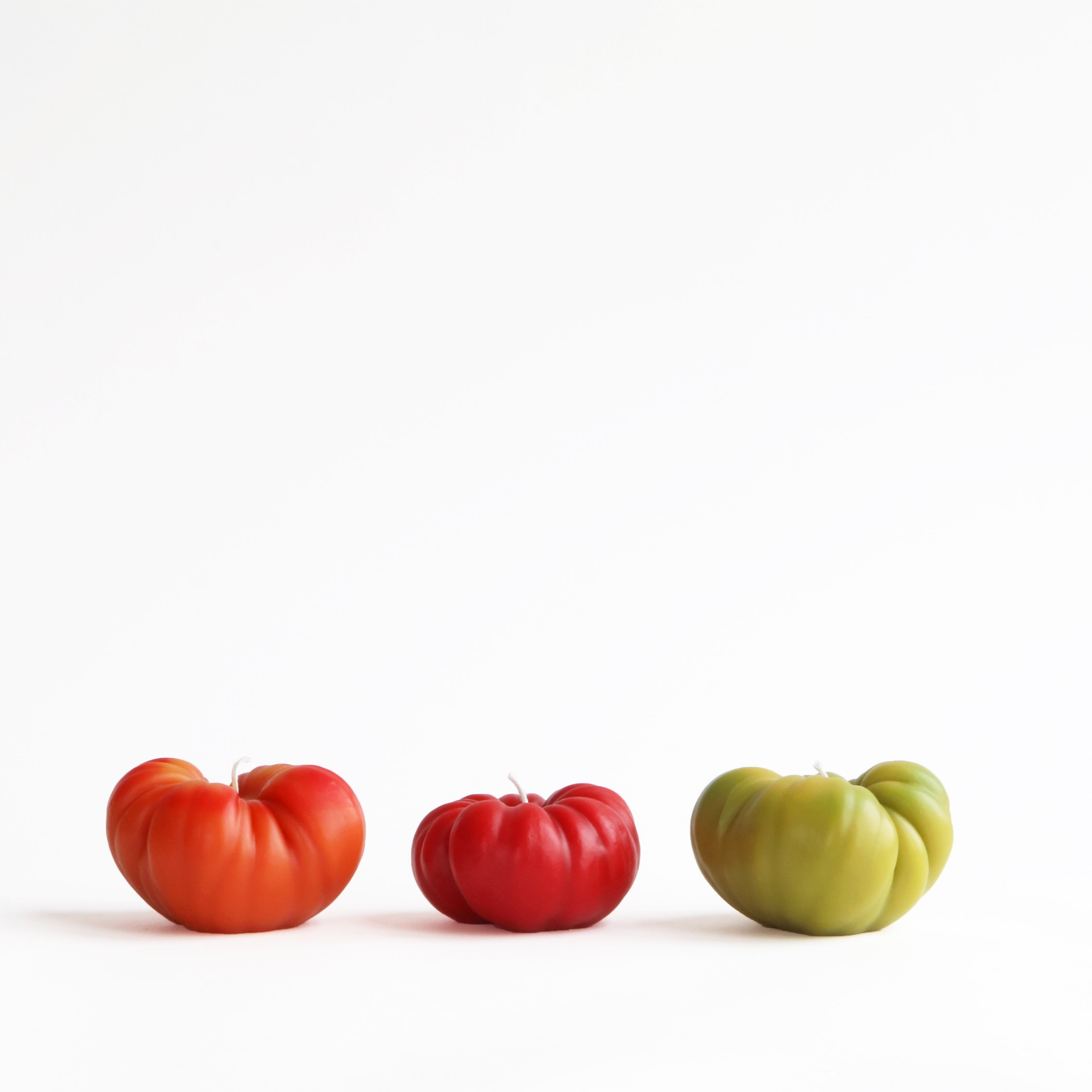 heirloom tomato beeswax candles in orange, green, and red