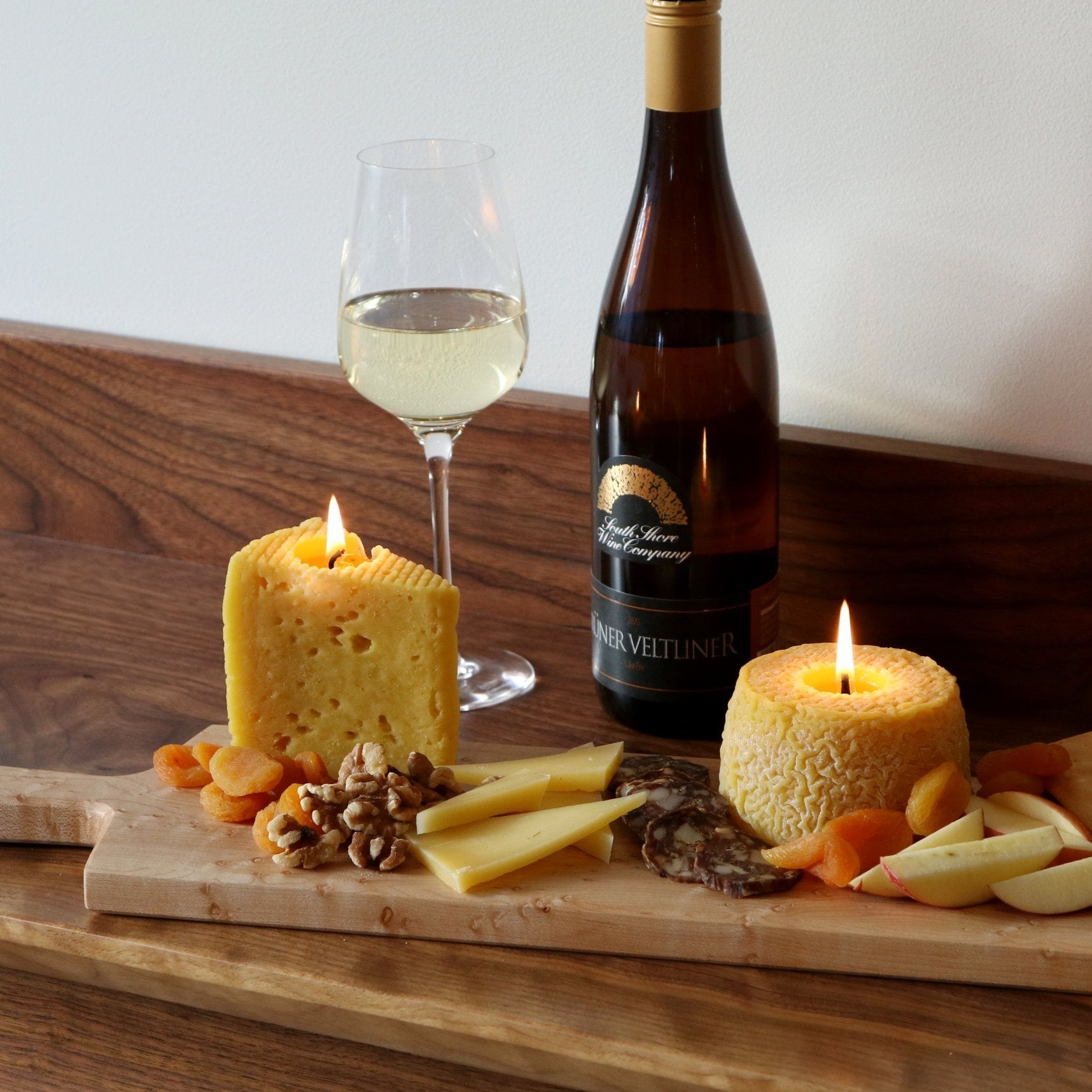 cheese board with cheese candles and wine