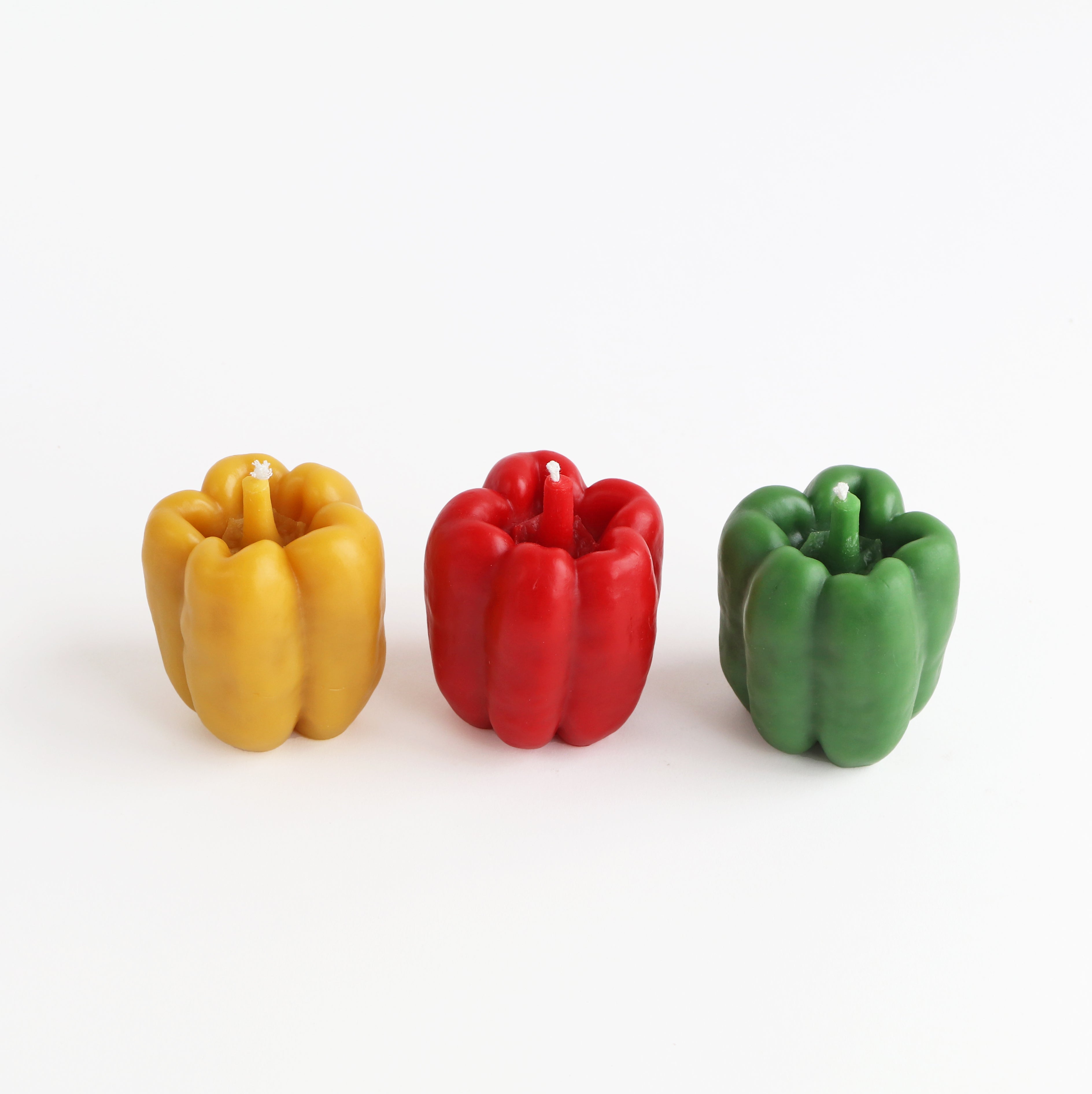 yellow, red, and green pepper candle from aerial angle