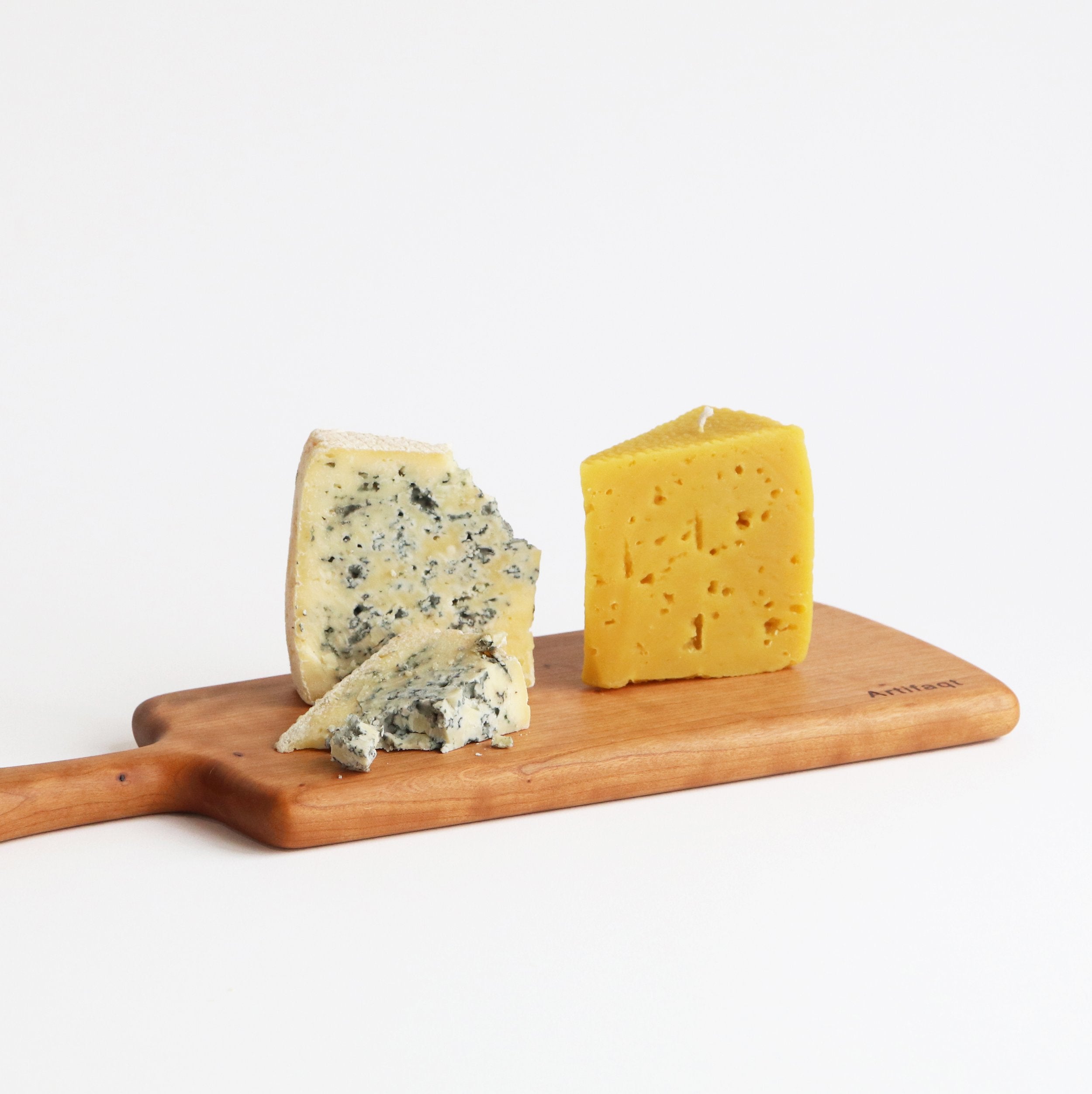 candle and blue cheese on a Artifaqt board