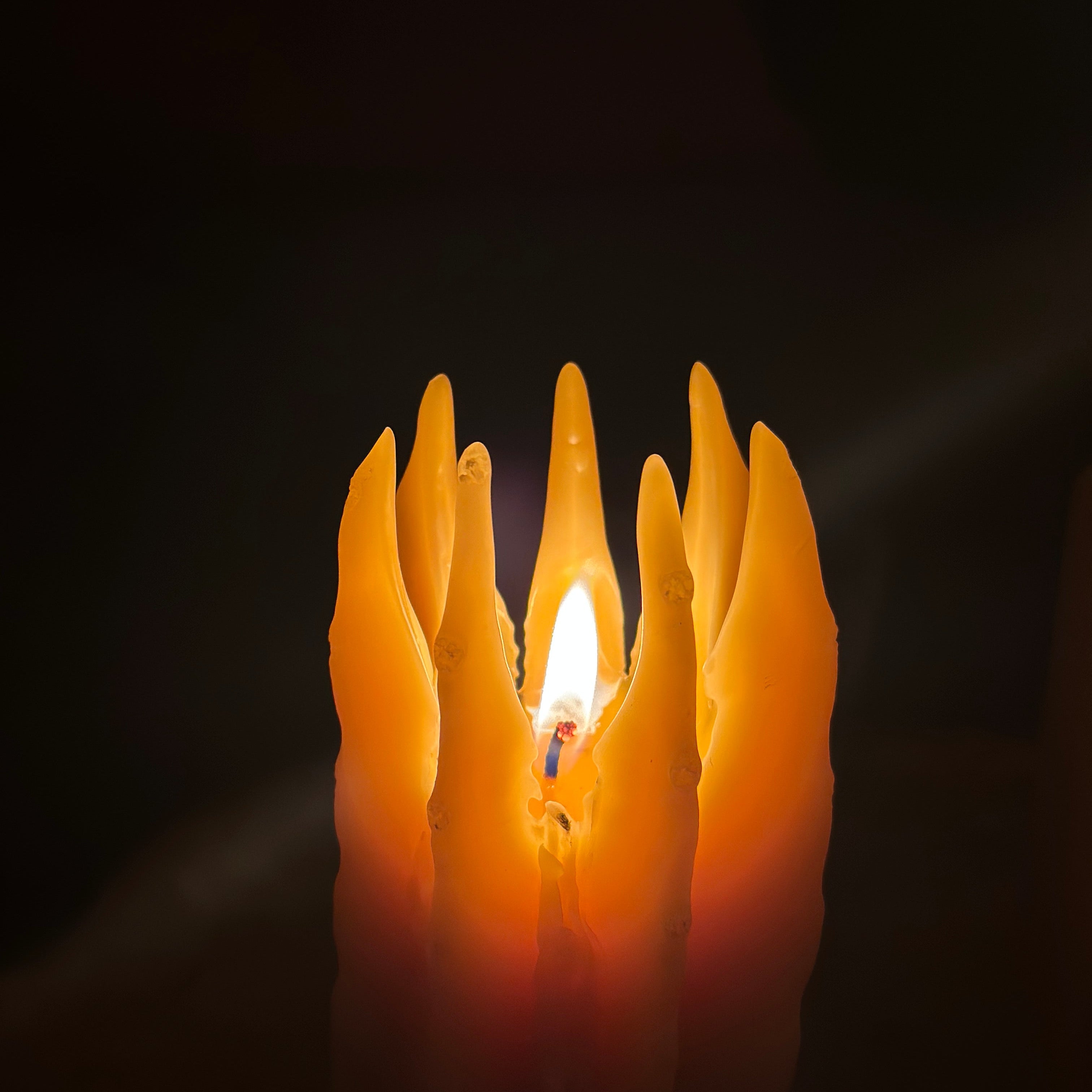 Flame-shaped light candle on a dark background