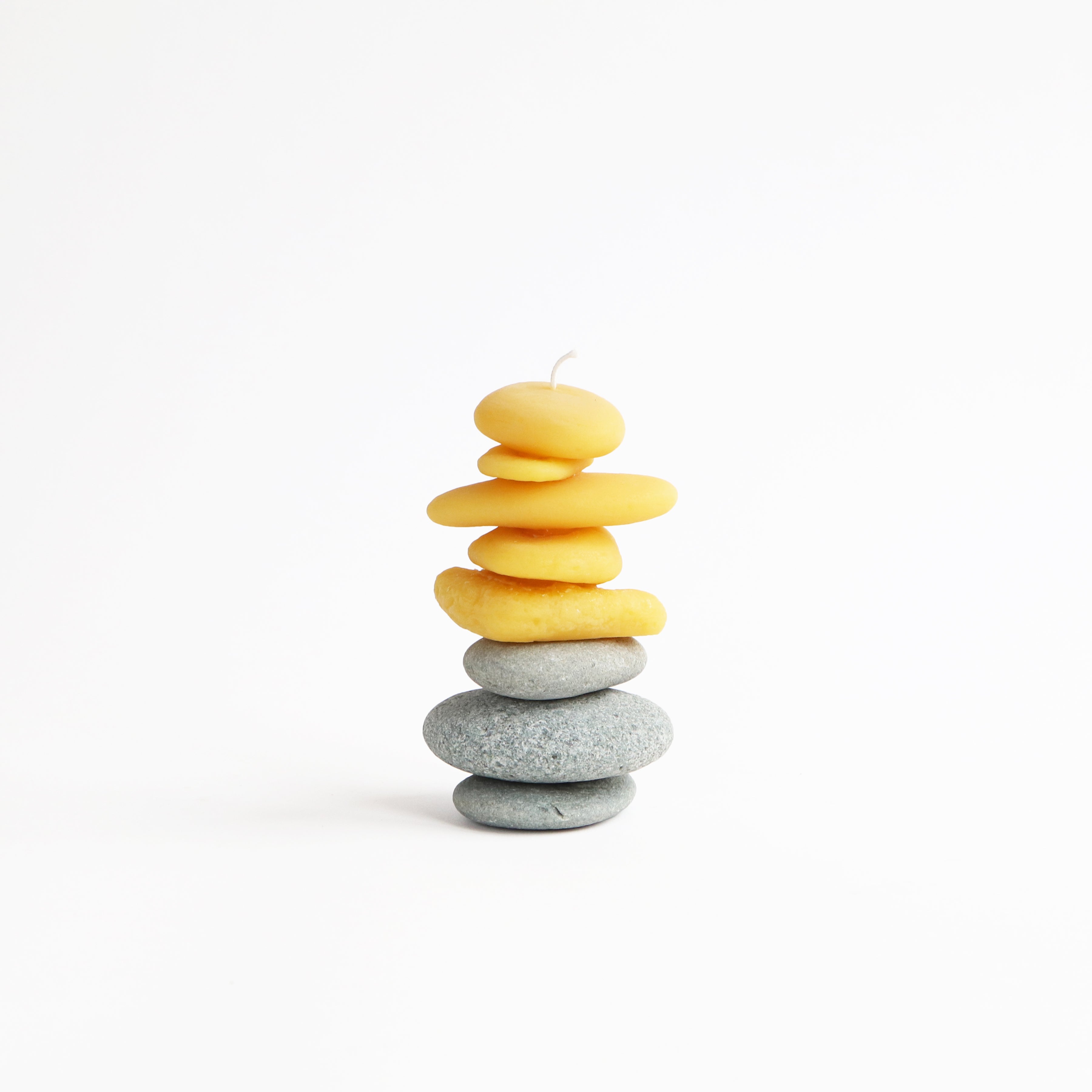 cairn candle on real beach pebbles