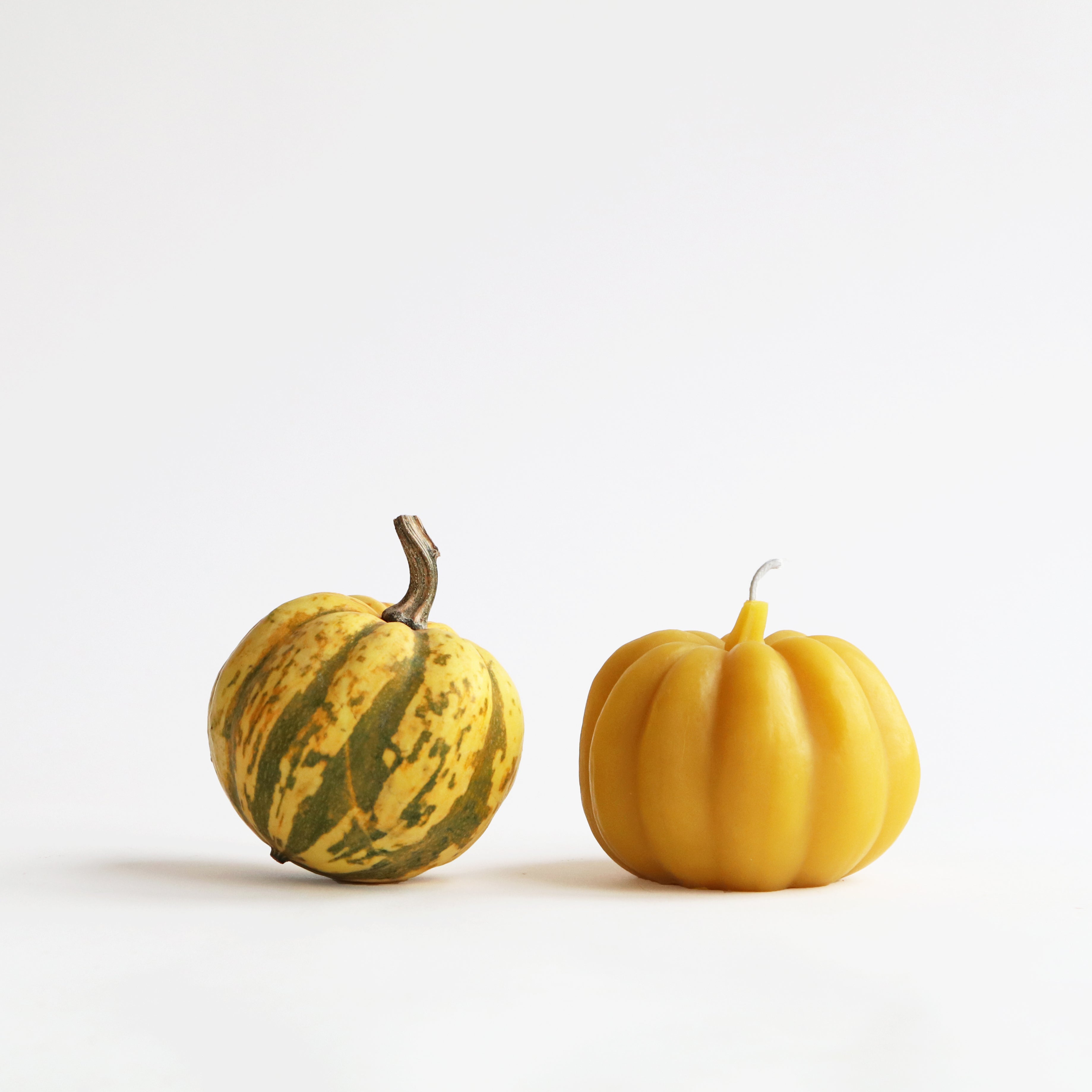 a carnival squash and a squash beeswax candle