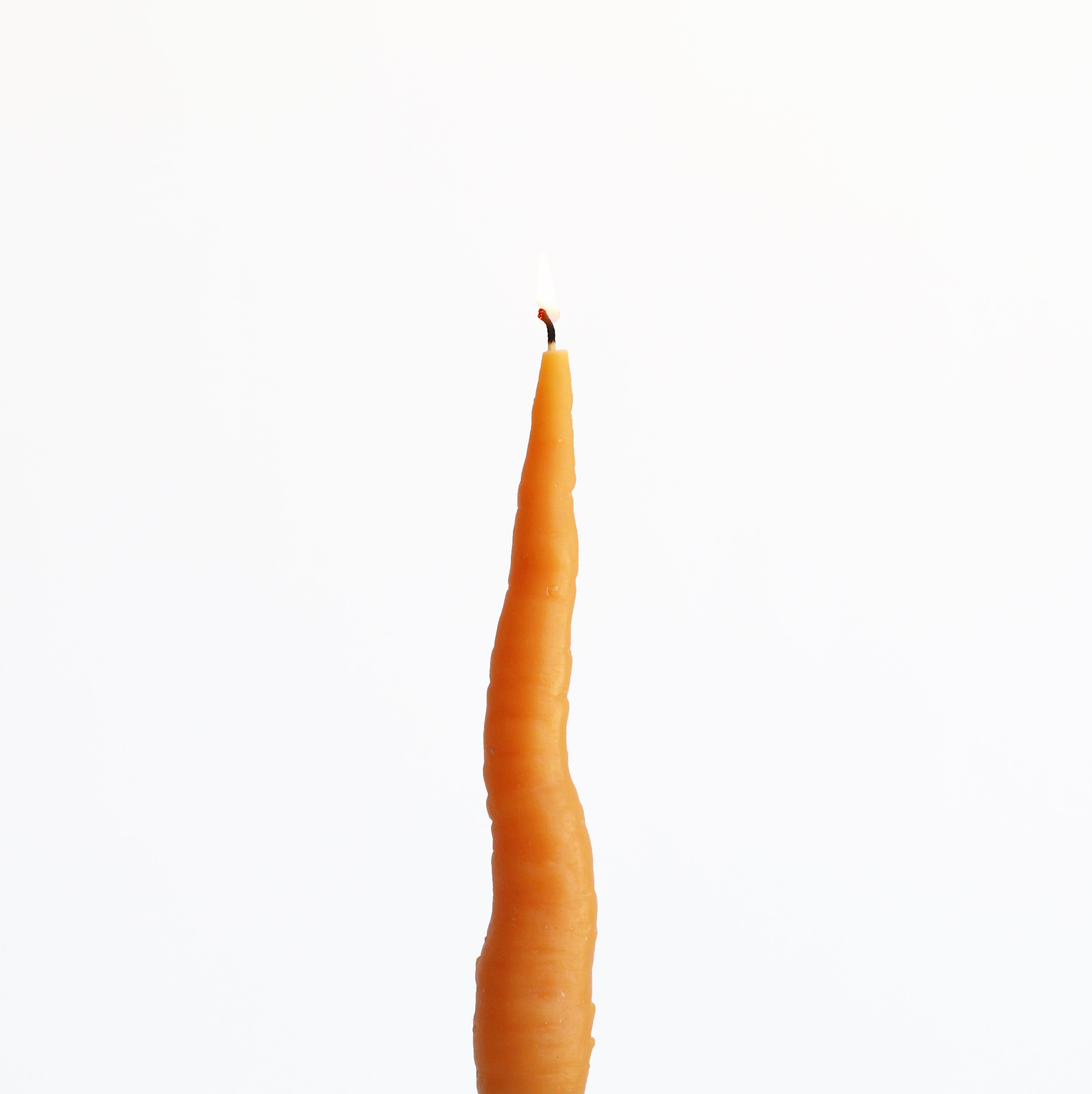 a lit carrot candle