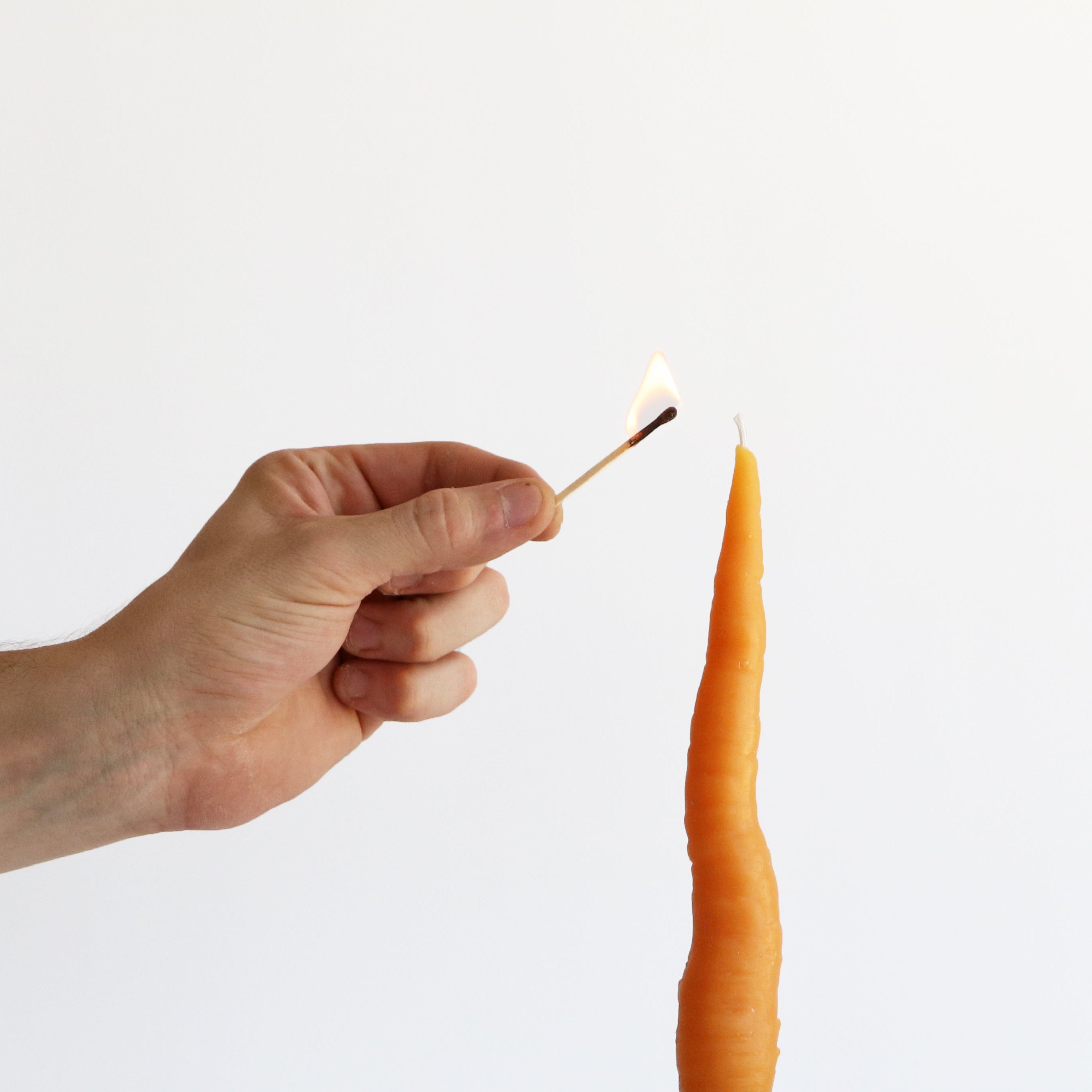match lighting carrot taper candle