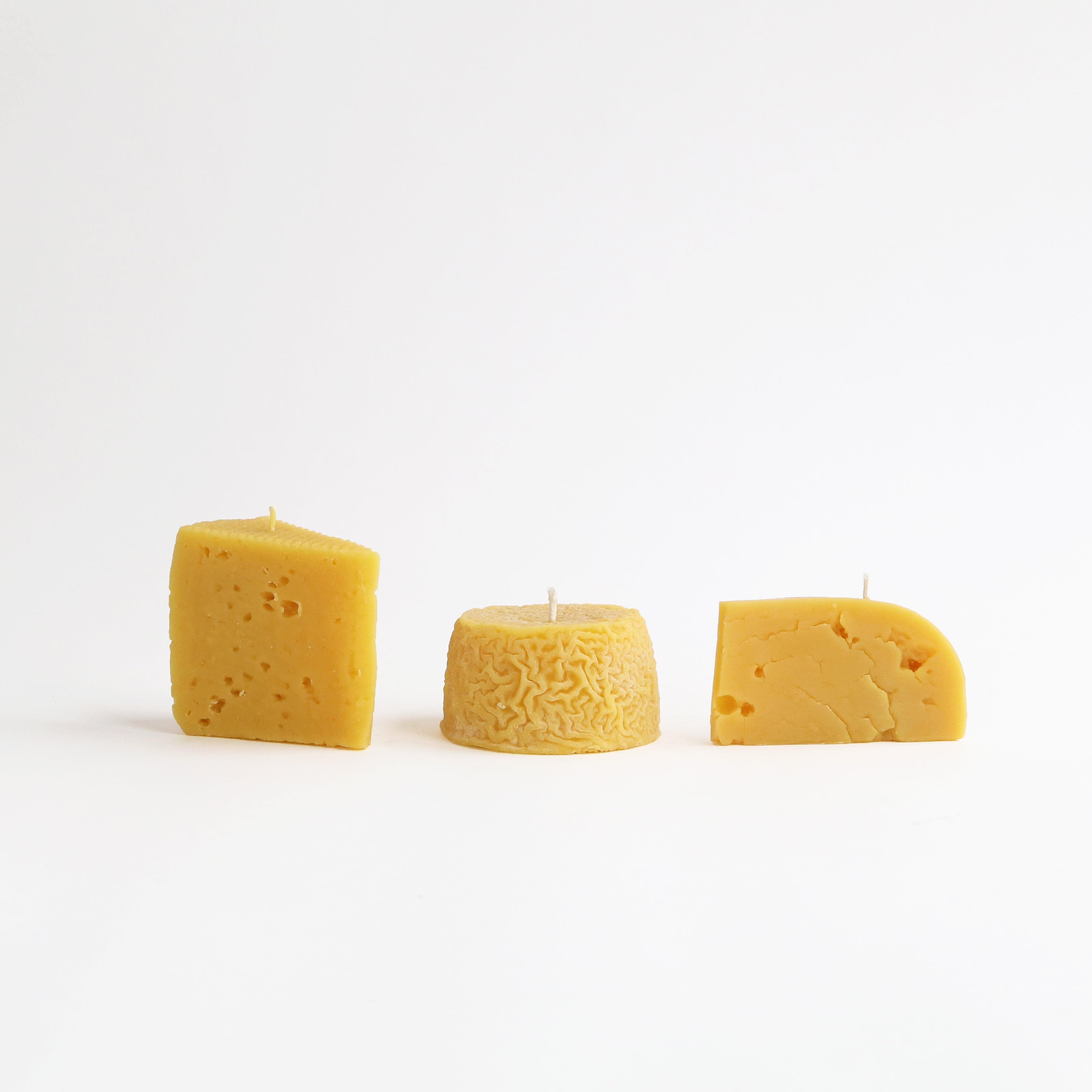 three beeswax cheese candles