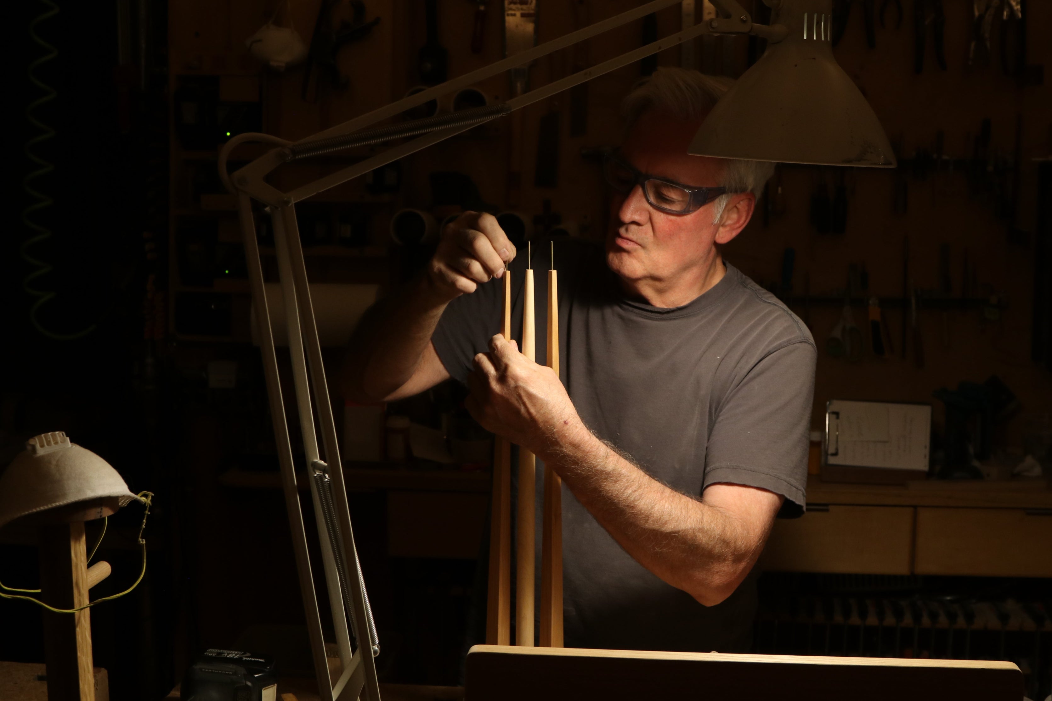 Man working in a workshop with tools and equipment around