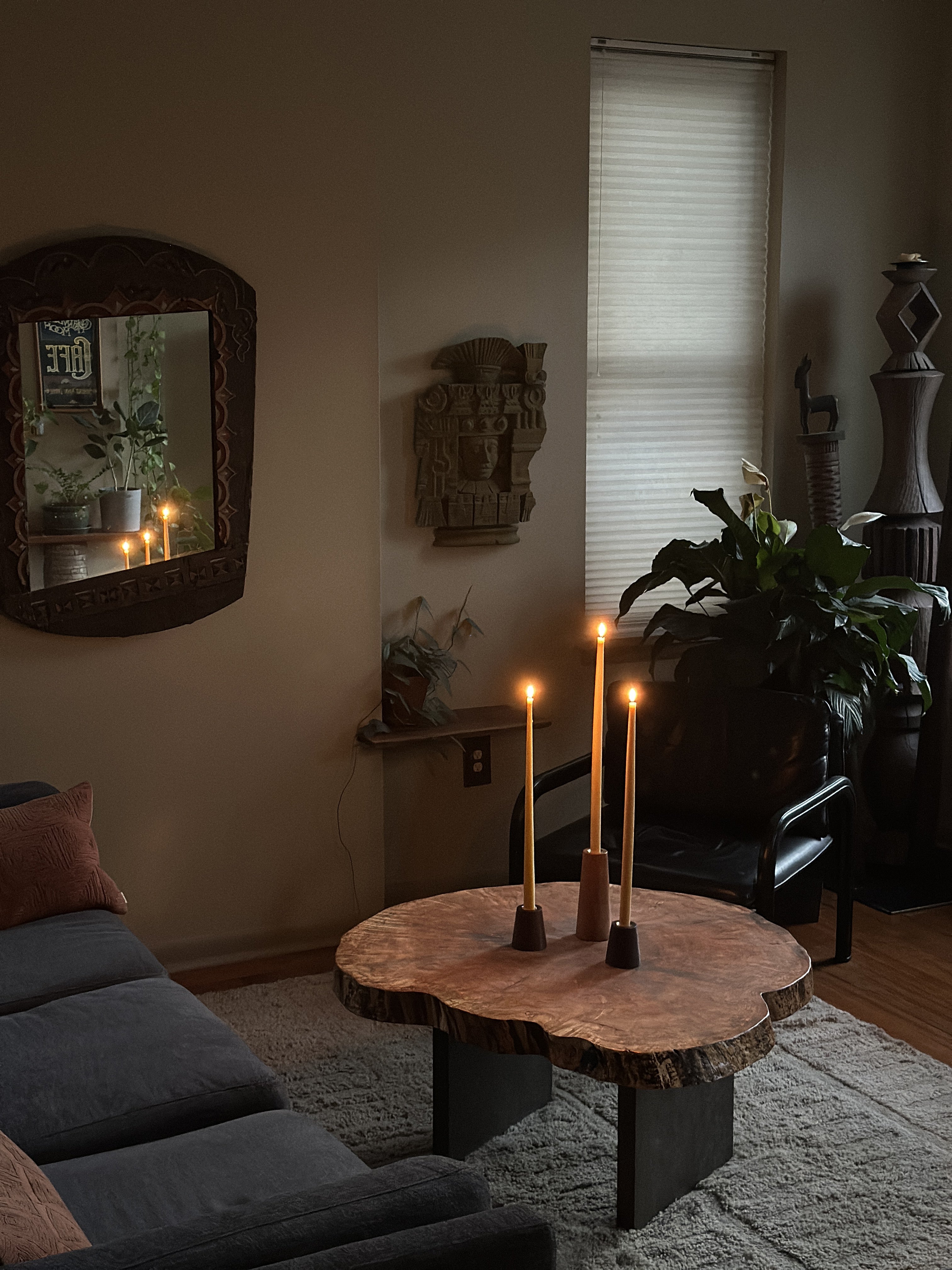 Living room with a wooden coffee table, candles, and decorative items.
