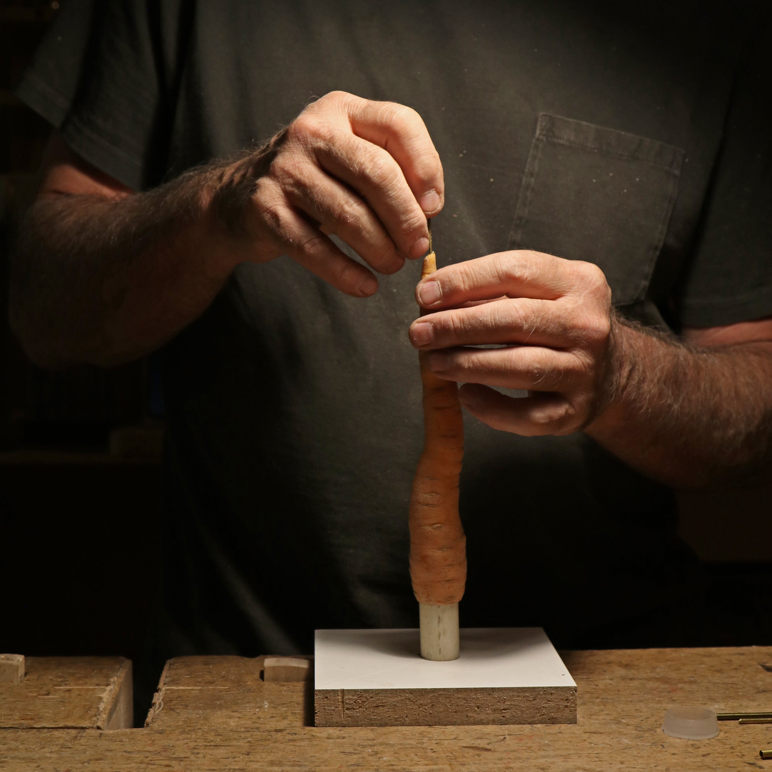 hands working on carrot candle mold