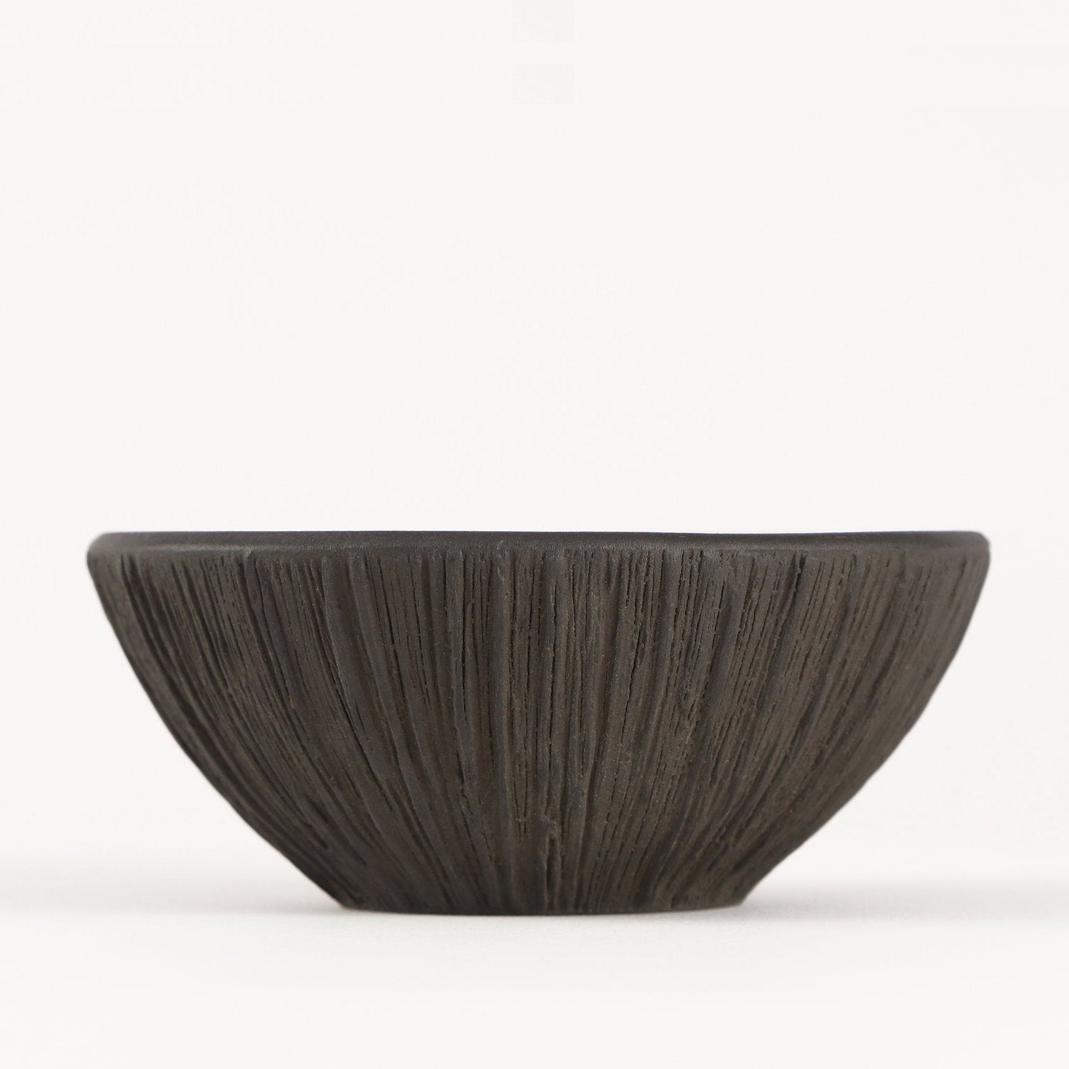 side view of textured small metal bowl