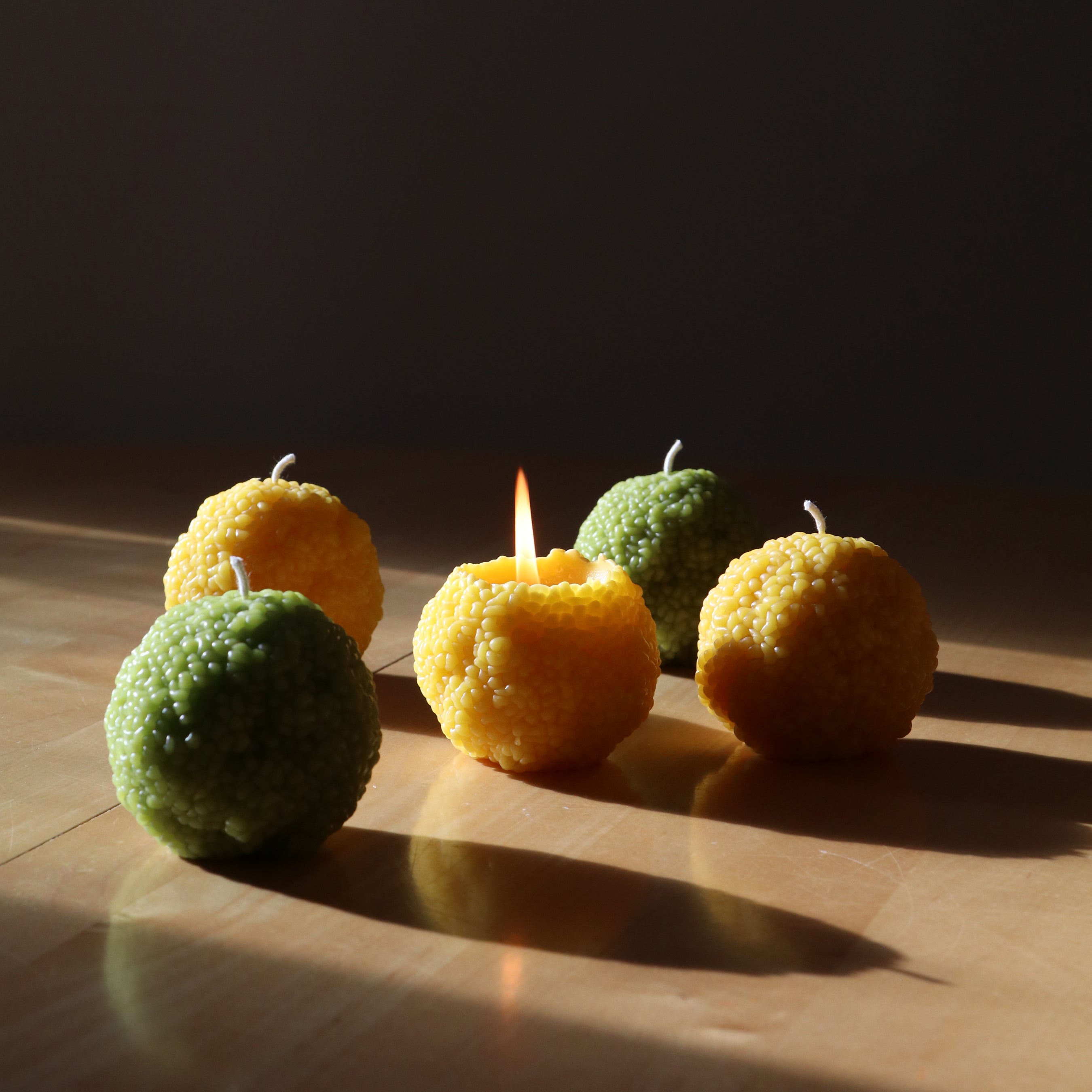osage orange candles in sunlight and shadow