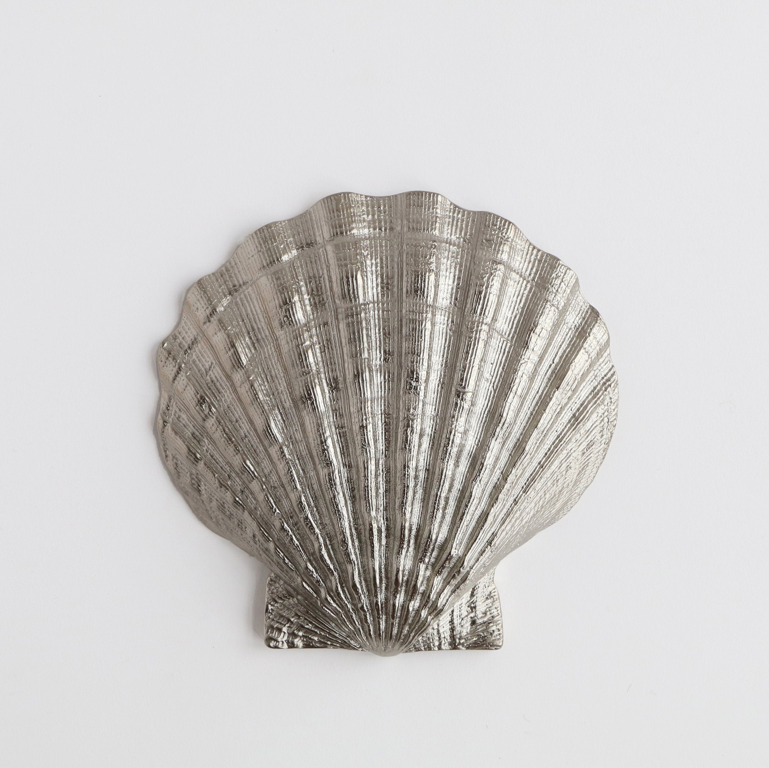 back of silver scallop shell dish