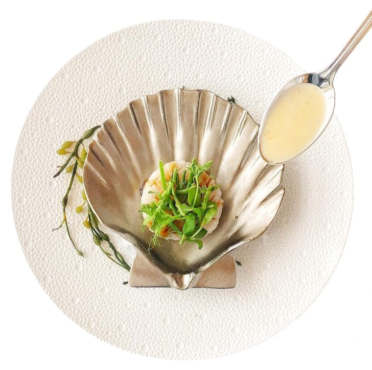 silver scallop shell dish with spoon and scallop