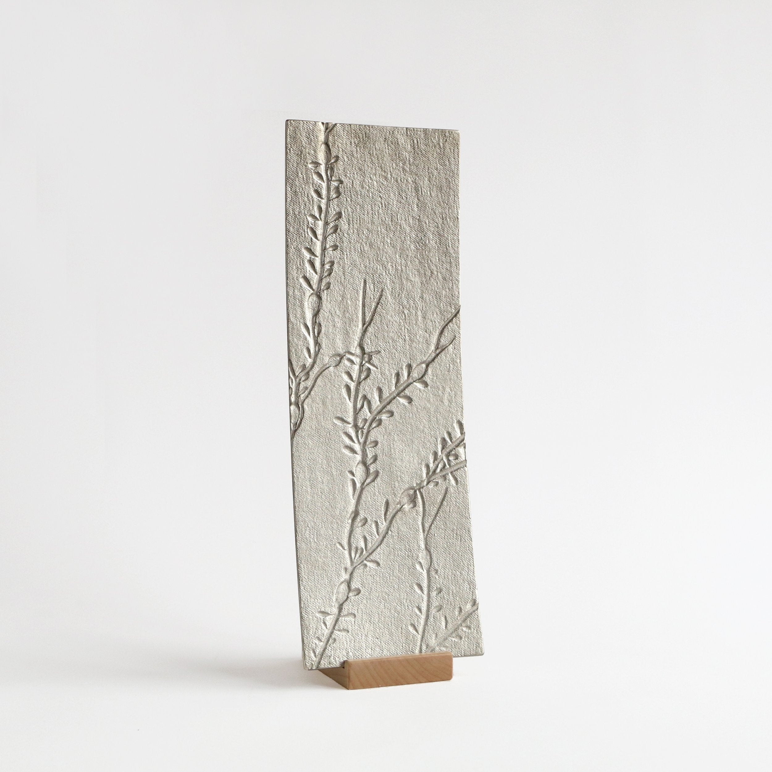 silver metal tray with seaweed impressions