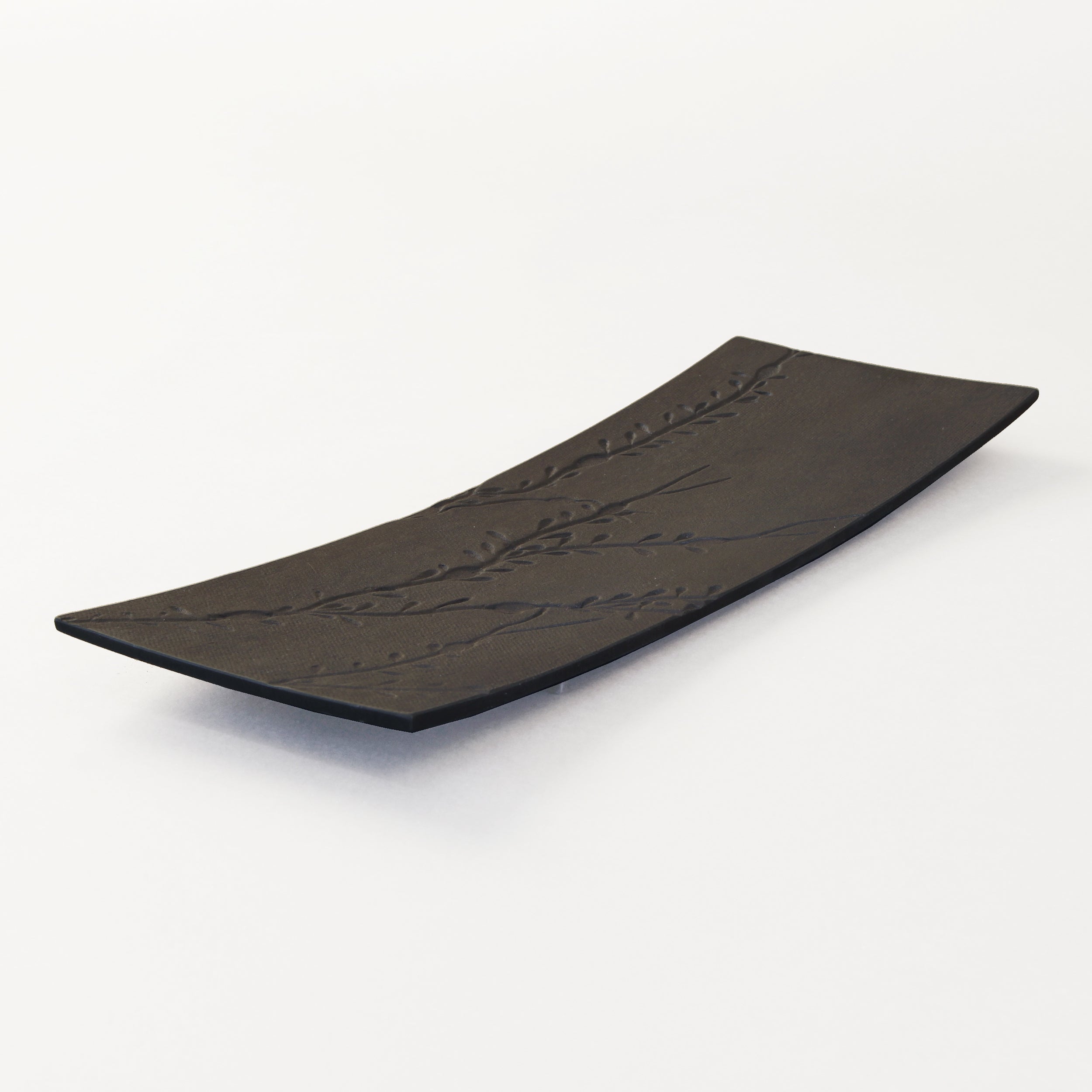 black metal platter with seaweed impressions