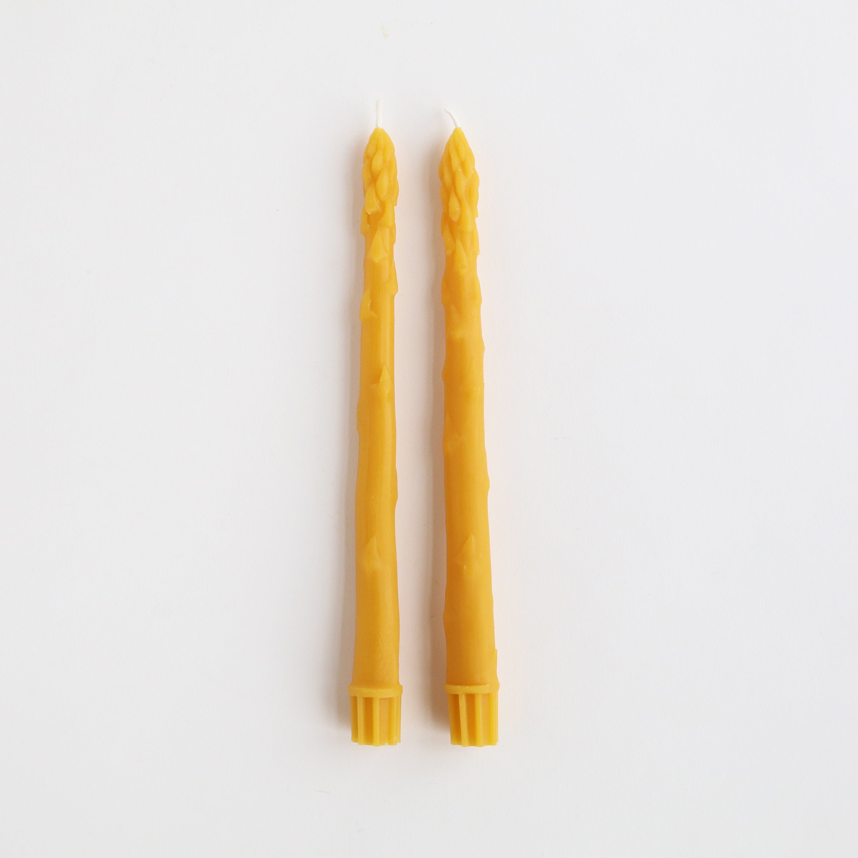 pair of yellow asparagus taper candles